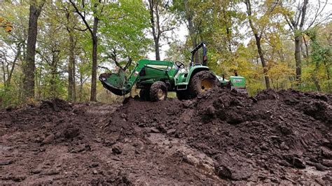 digging a pond on tractor